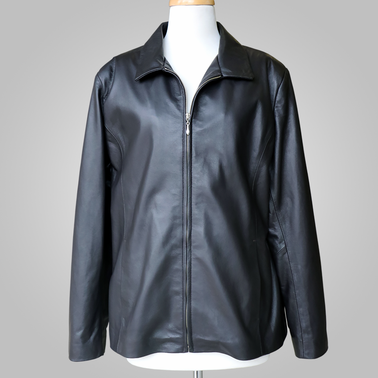 Women’s black leather jacket with collar and front zip on a mannequin