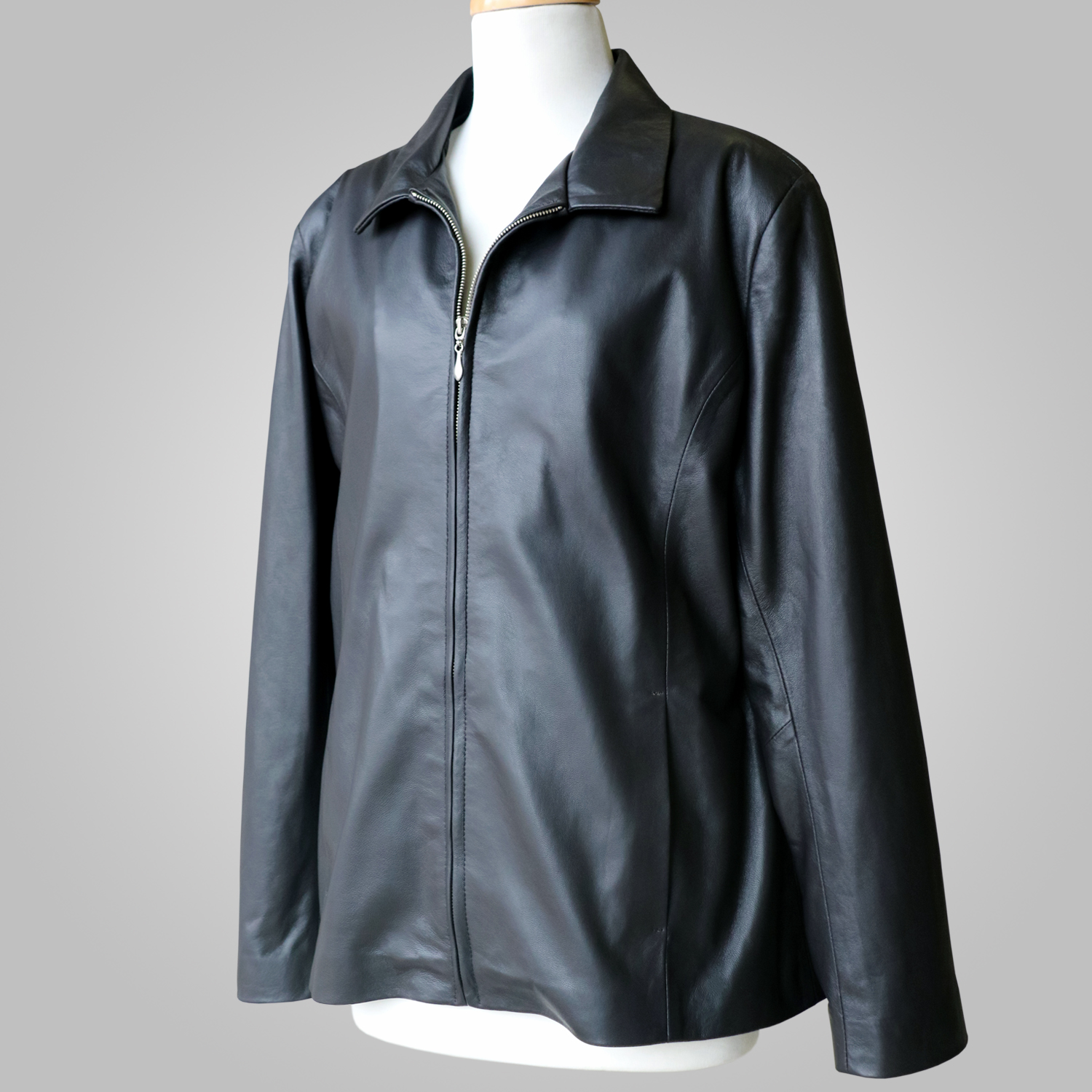 Women’s black leather jacket at an angled front view on a mannequin