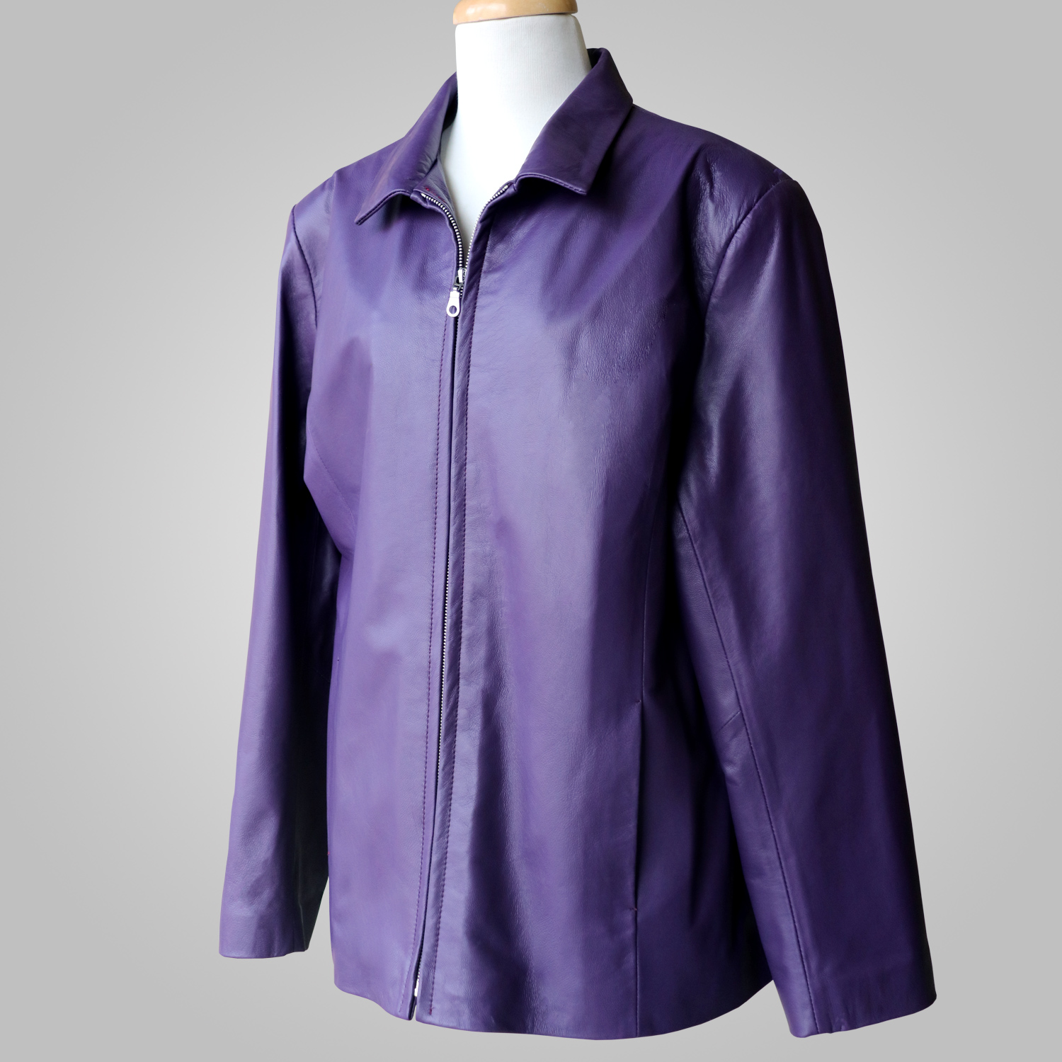Women’s dark purple leather jacket at an angled front view on a mannequin