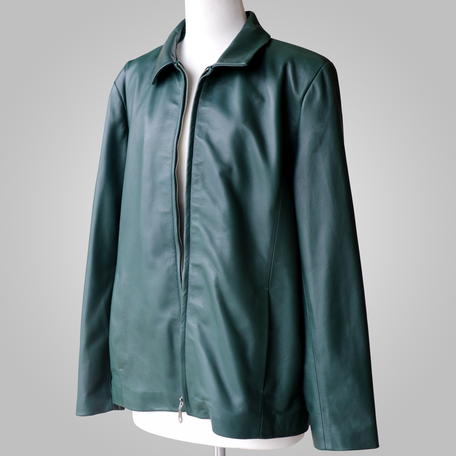 Women’s green leather jacket open at the front on a mannequin