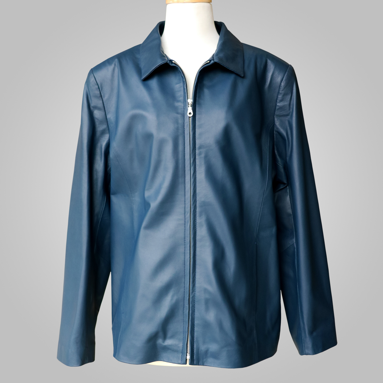 Women’s navy leather jacket with collar and front zip on a mannequin